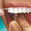 Hold the floss against the tooth and gently